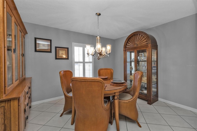 tiled dining area featuring a notable chandelier