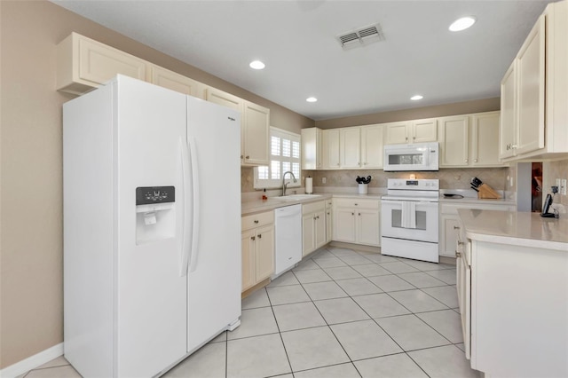 kitchen featuring decorative backsplash, light tile patterned flooring, white appliances, and sink