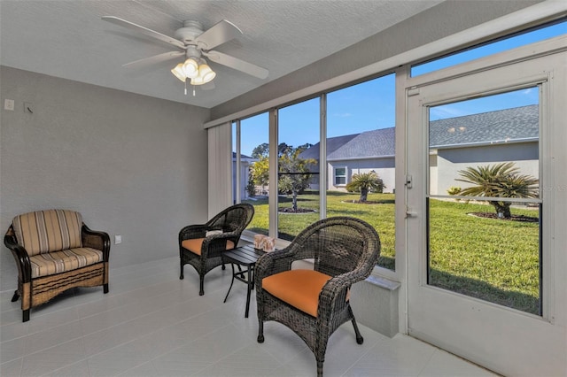 sunroom featuring ceiling fan