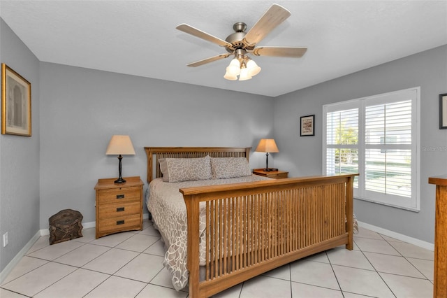 bedroom featuring light tile patterned floors and ceiling fan