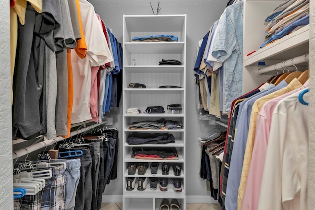 walk in closet with tile patterned floors