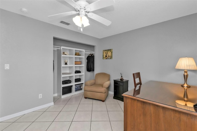 tiled office space with built in shelves and ceiling fan