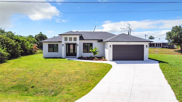 view of front of house featuring a front yard and a garage