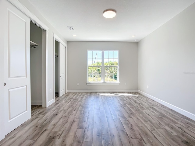 unfurnished bedroom featuring light wood-type flooring