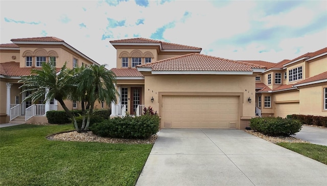 mediterranean / spanish-style home with a garage and a front lawn