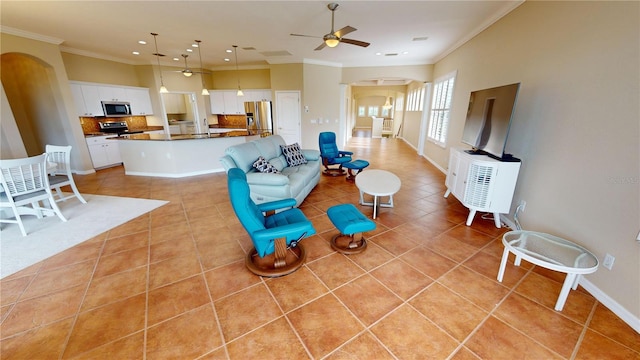 living room with ceiling fan, light tile patterned flooring, and ornamental molding