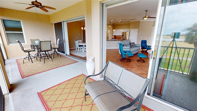 sunroom / solarium featuring ceiling fan