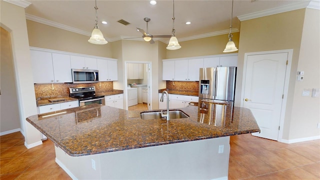 kitchen with white cabinets, sink, separate washer and dryer, a large island, and stainless steel appliances