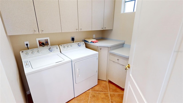 washroom featuring light tile patterned flooring, cabinets, and independent washer and dryer