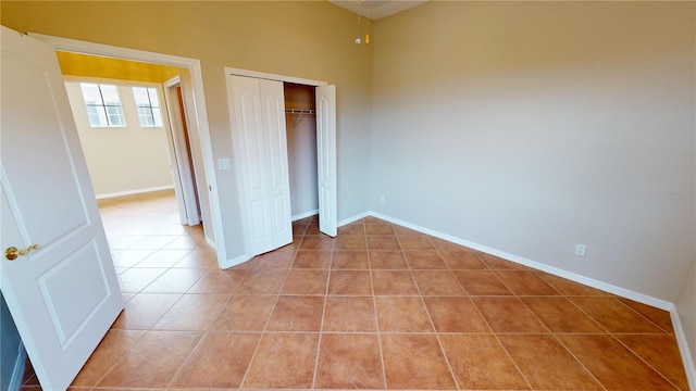 unfurnished bedroom featuring a closet and light tile patterned flooring