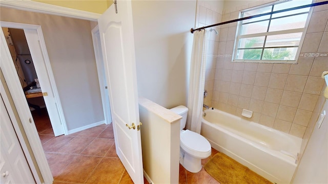 bathroom featuring tile patterned flooring, toilet, and shower / bathtub combination with curtain