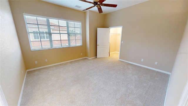 unfurnished bedroom featuring light colored carpet and ceiling fan