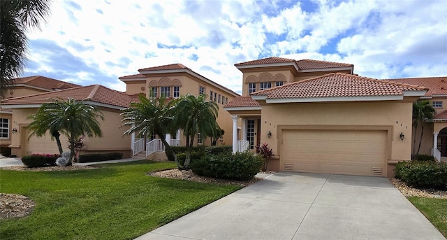 mediterranean / spanish home with a front yard and a garage