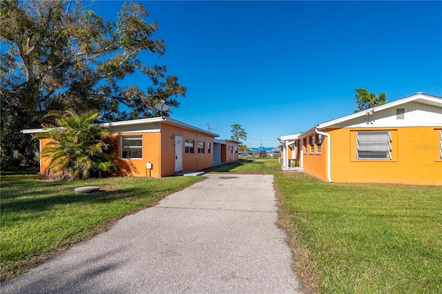 view of side of property with a yard