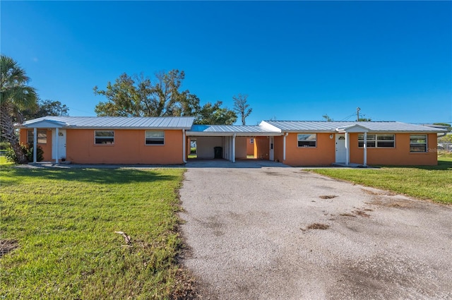 ranch-style house with a front lawn and a carport