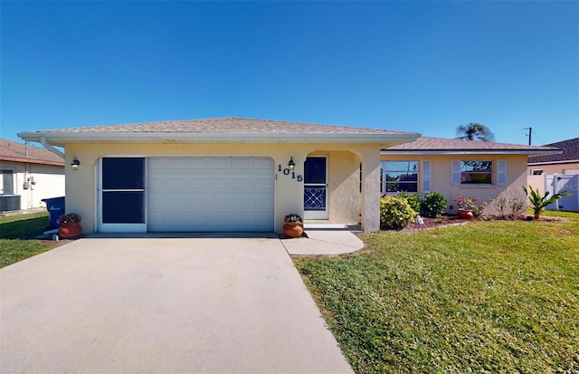 single story home featuring central air condition unit, a front lawn, and a garage