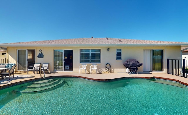 view of swimming pool featuring grilling area and a patio area