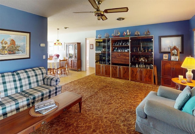 living room with carpet flooring and ceiling fan