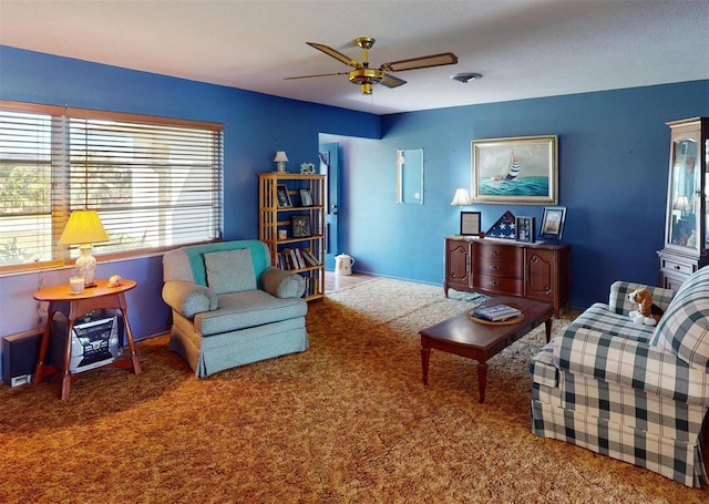 living room featuring carpet flooring, a textured ceiling, and ceiling fan