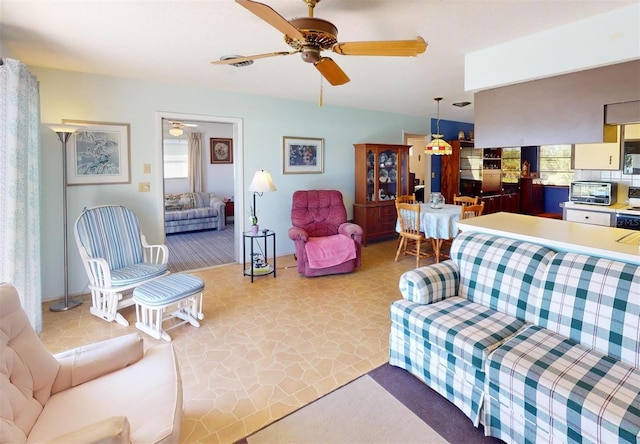 living room featuring ceiling fan and light carpet