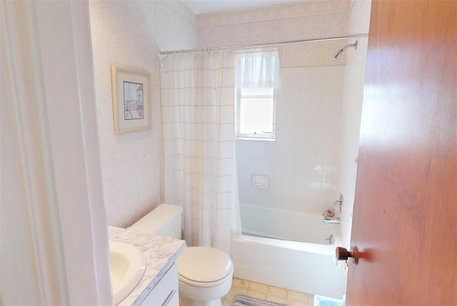 full bathroom featuring tile patterned flooring, tiled shower / bath combo, toilet, and vanity