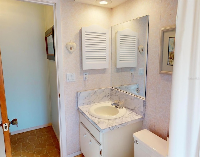 bathroom featuring tile patterned flooring, vanity, and toilet