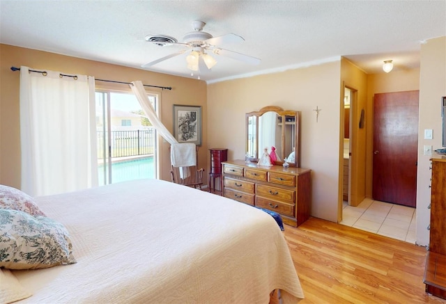 bedroom featuring access to exterior, ceiling fan, light hardwood / wood-style flooring, and ensuite bathroom