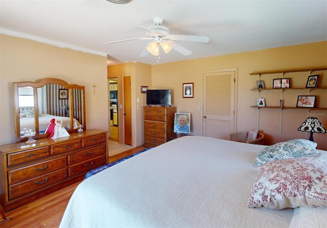 bedroom featuring ceiling fan, light wood-type flooring, and a closet