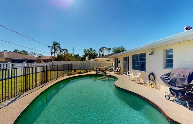 view of pool featuring area for grilling and a patio area