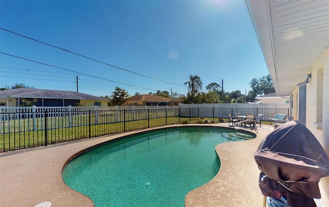 view of swimming pool featuring a grill and a patio