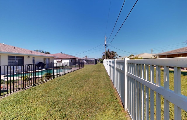 view of yard with a fenced in pool