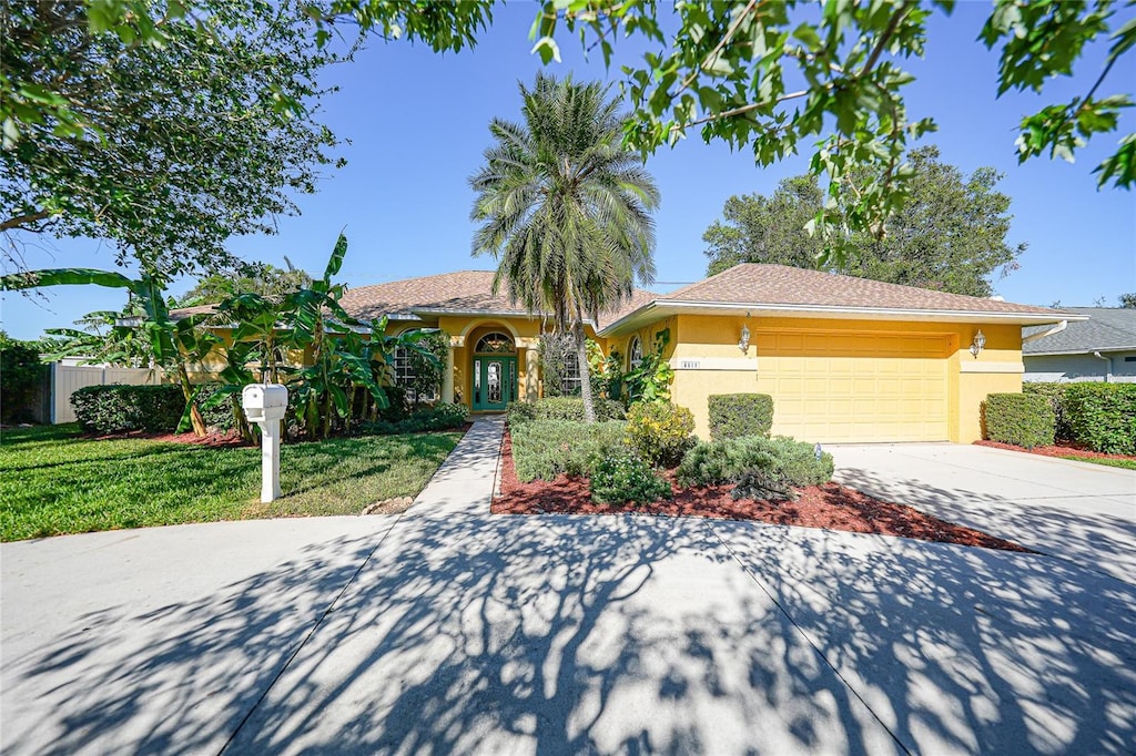 view of front facade featuring a garage and a front lawn