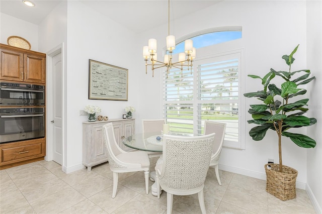 tiled dining room featuring a notable chandelier