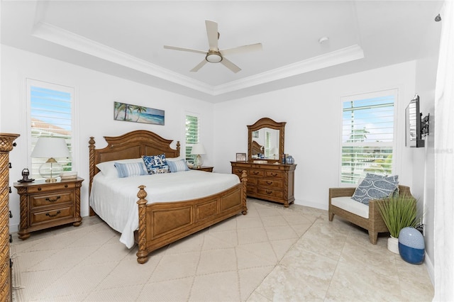 bedroom with a raised ceiling and ceiling fan