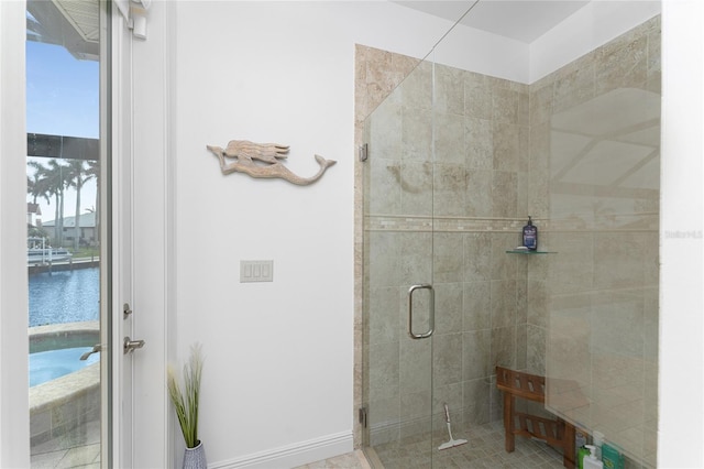 bathroom featuring walk in shower and a water view