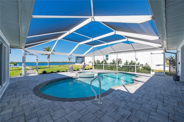 view of pool with glass enclosure, an in ground hot tub, and a patio