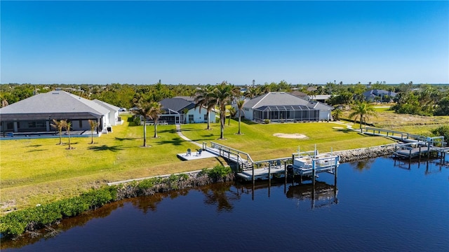 dock area featuring a water view, a lawn, and glass enclosure