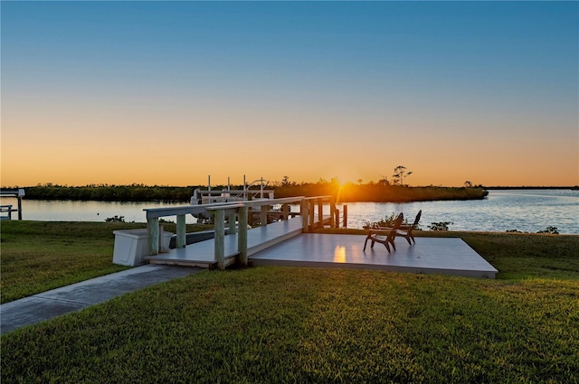 dock area with a water view and a lawn