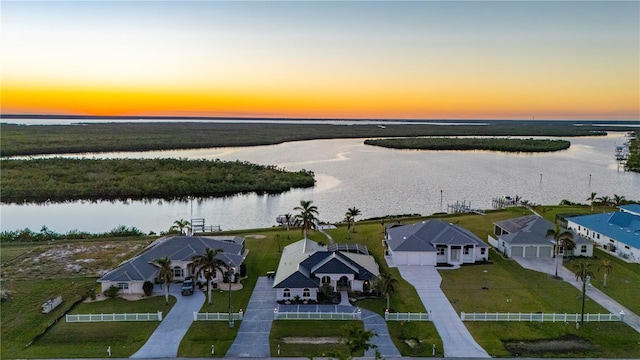 aerial view at dusk with a water view