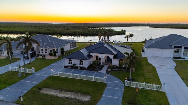 aerial view at dusk with a water view