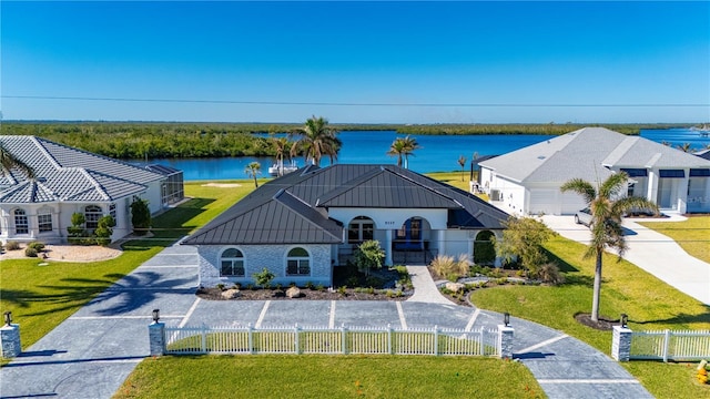 view of front facade featuring a water view and a fenced front yard