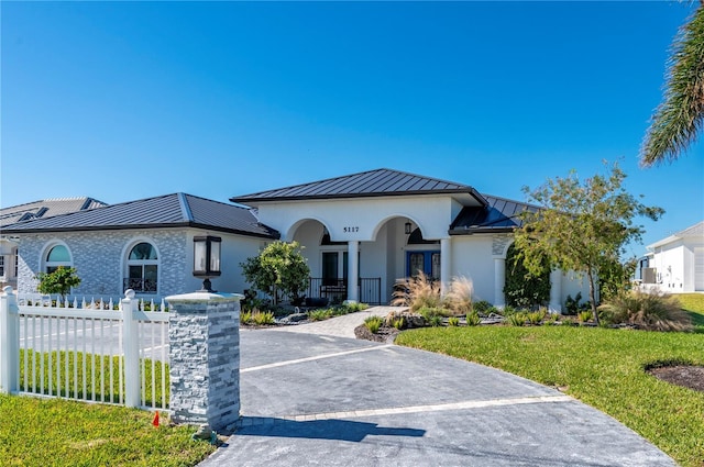 view of front of house with a front yard and french doors