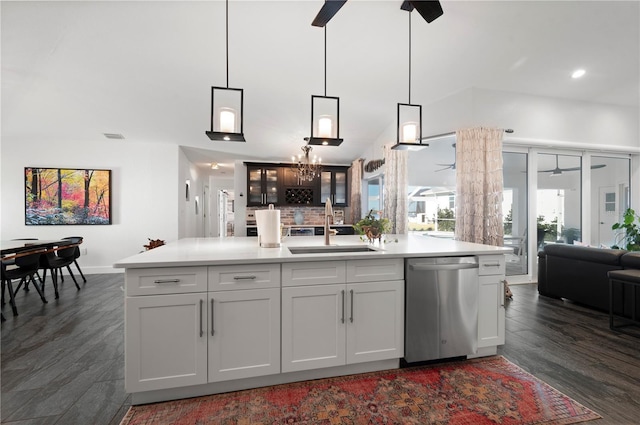 kitchen featuring dishwasher, pendant lighting, sink, white cabinetry, and an island with sink