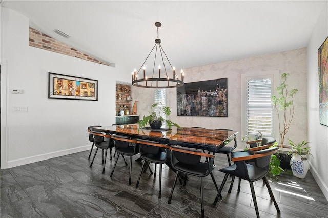 dining area featuring lofted ceiling and a notable chandelier