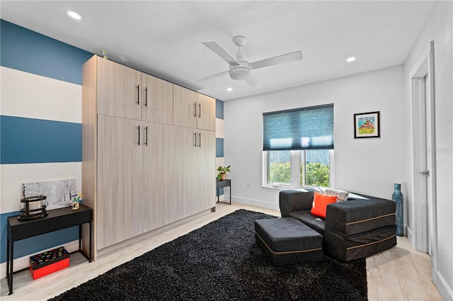 sitting room with ceiling fan and light hardwood / wood-style floors