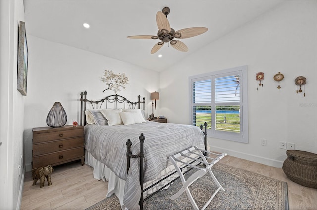 bedroom featuring light wood-type flooring, ceiling fan, and lofted ceiling