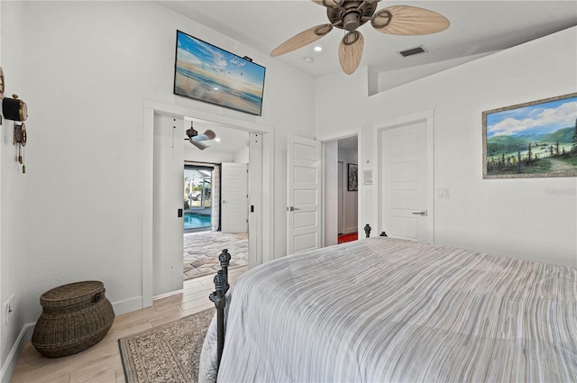 bedroom featuring ceiling fan, lofted ceiling, and light hardwood / wood-style floors