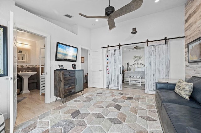 living room featuring light hardwood / wood-style floors, a barn door, and sink