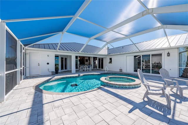 view of pool with an in ground hot tub, a lanai, and a patio