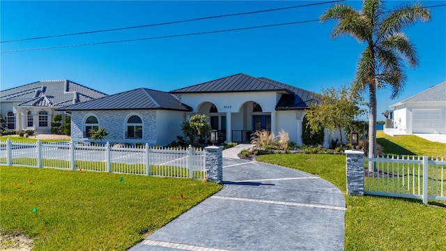 mediterranean / spanish home with a front yard